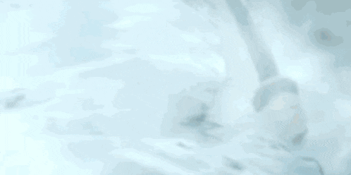 a person is holding a sword in their hand and it is spinning around in the air .