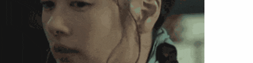 a close up of a person 's face in a dark room with a blurred background .