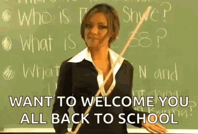 a woman is standing in front of a blackboard holding a wooden stick and saying `` want to welcome you all back to school ''