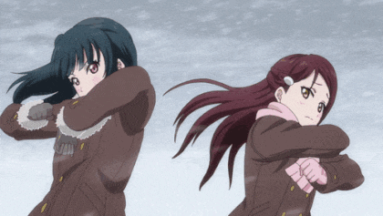 a couple of anime girls standing in the snow