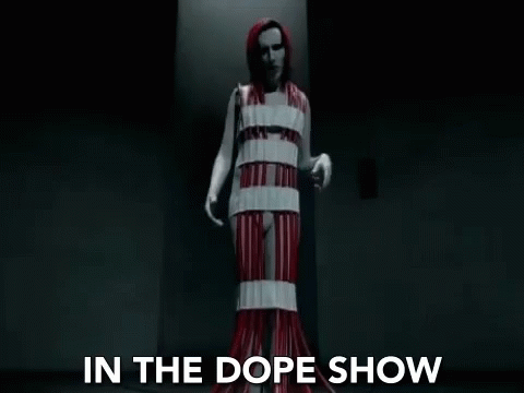 In The Dope Show Standing Still GIF - In The Dope Show Standing Still Red Gown GIFs