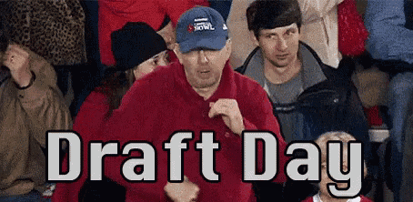 a man in a blue hat is dancing in a crowd of people with the words draft day written above him