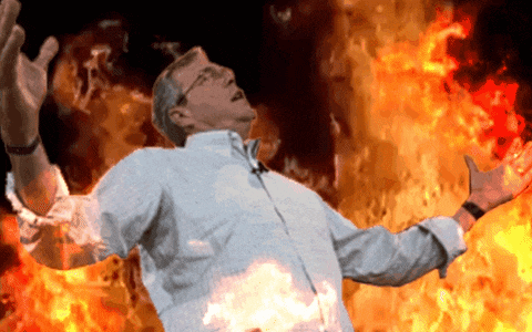 a man with his arms outstretched is surrounded by flames
