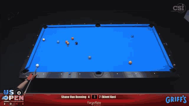 a pool table with blue cloth and a man holding a cue