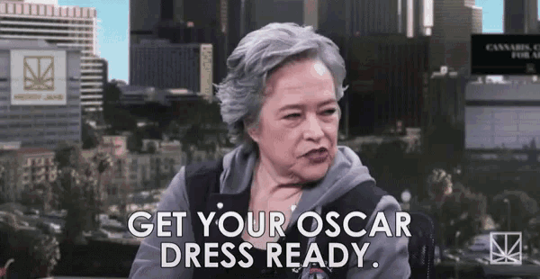 a woman says get your oscar dress ready while sitting in front of a city