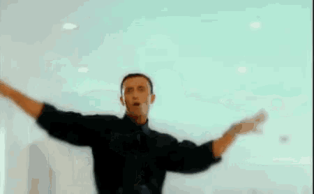 a man with his arms outstretched in a blurry photo