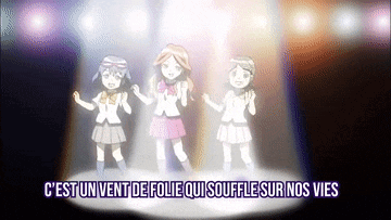 three girls are dancing on a stage with the words c'est un vent de folie qui souffle sur nos vies