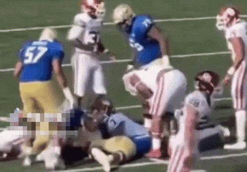 a football player with the number 57 on his jersey is laying on the field