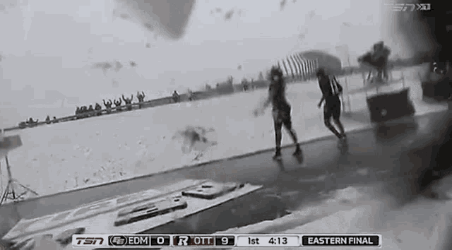 a couple of people walking in the rain with a score of 9 to 9