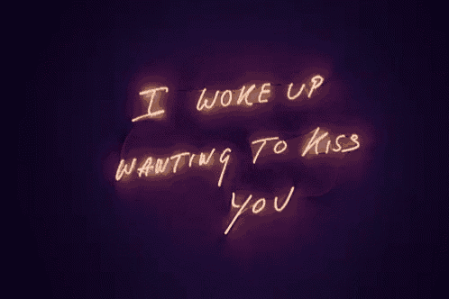 a neon sign that says " i woke up wanting to kiss you " on it