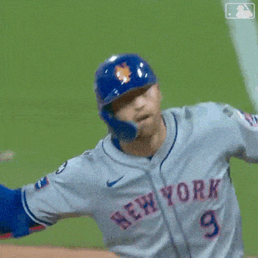 a baseball player wearing a new york jersey is swinging his bat