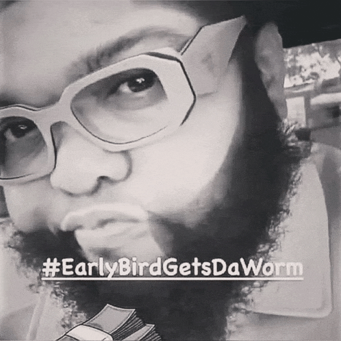 a man with glasses and a beard is holding a stack of money in his hand ..