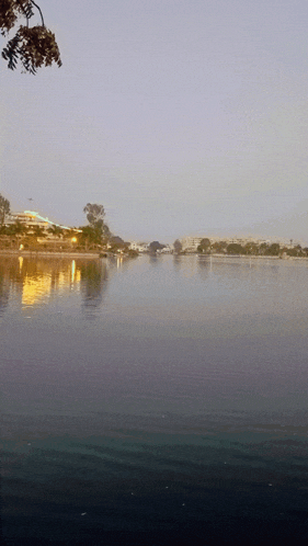 a large body of water with a few buildings in the background