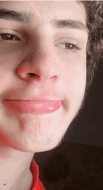a close up of a person 's face with a red lip