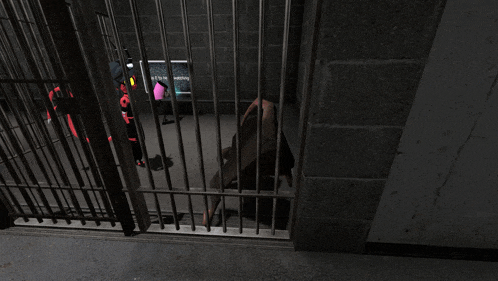 a man behind bars in a jail cell with a sign behind him that says it 's a waiting room