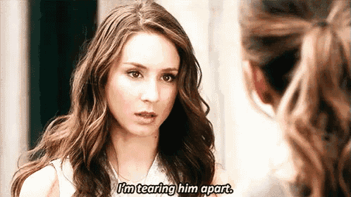 a woman is tearing him apart while talking to another woman .