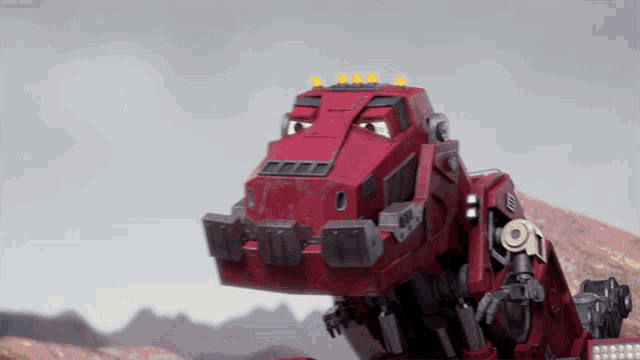 a red robot with a yellow light on the top of it