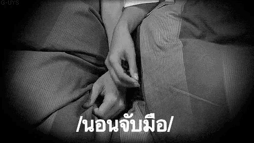 a black and white photo of a person laying in bed with a foreign language .