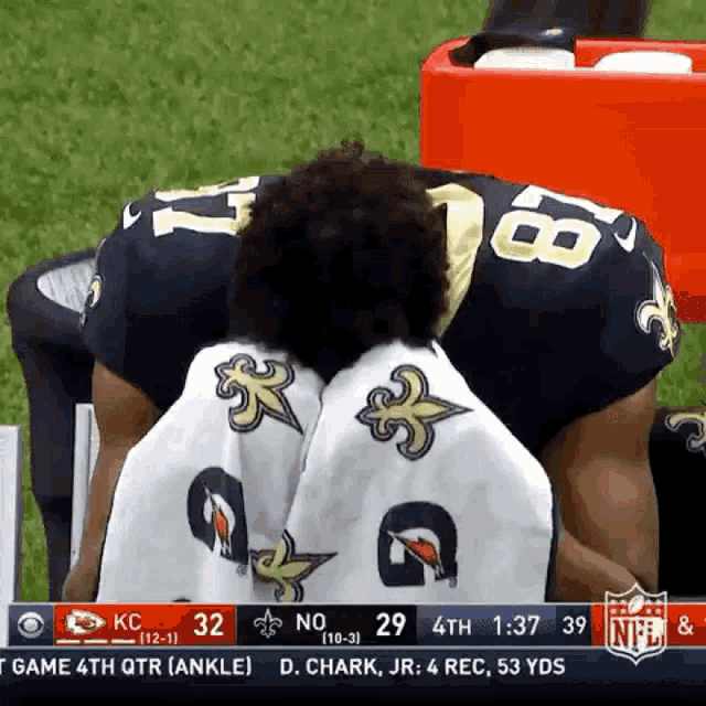 a football player with the number 18 on his back kneeling down