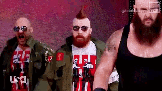 a group of men with beards are standing next to each other .
