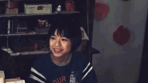 a young boy wearing a shirt that says our on it