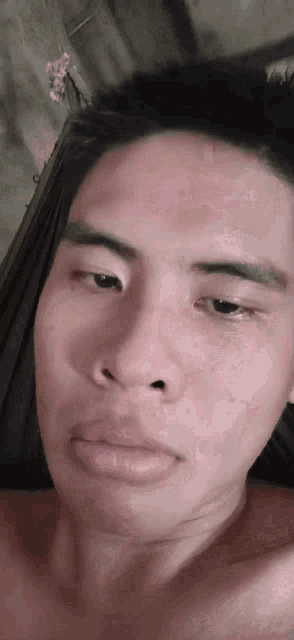 a close up of a man 's face without a shirt