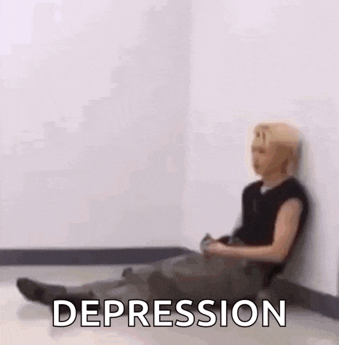 a person is sitting on the floor with their legs crossed and the word depression written on the floor .