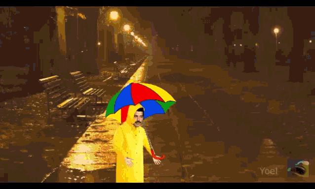 a man in a yellow raincoat holds a colorful umbrella in the rain
