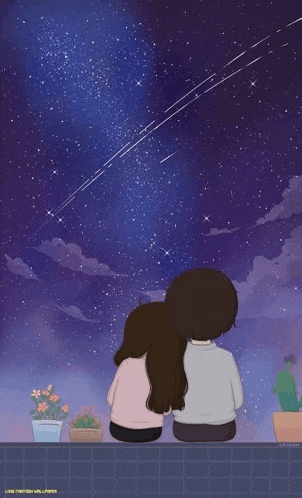 a couple sitting on a balcony looking at the stars