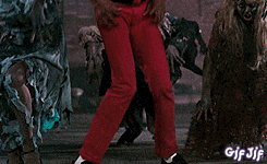 a man in a red jacket stands in front of a crowd of zombies and says aaow