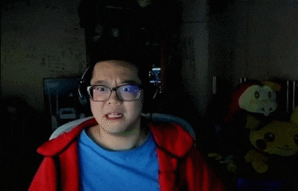 a young man wearing glasses and headphones is sitting in a chair .