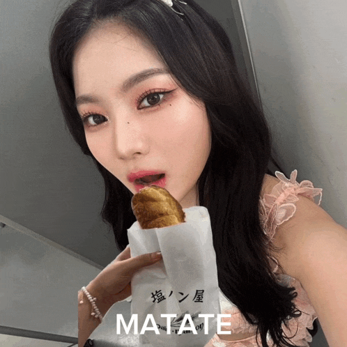 a woman in a pink dress is holding a bag that says matate on it