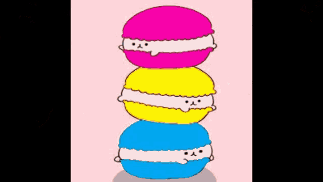 three colorful macarons stacked on top of each other on a pink background