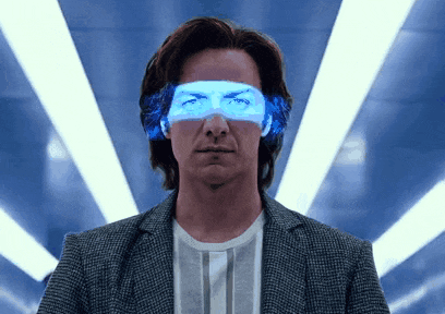 a man in a suit and striped shirt has a pair of blue glasses on his eyes