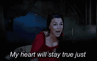 a woman in a red dress is saying `` my heart will stay true just '' while holding her chest .