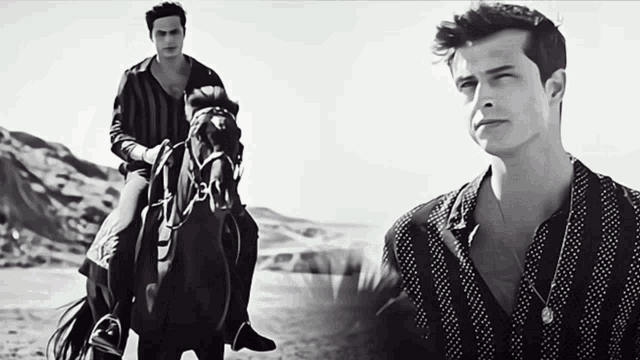 a man riding a horse next to another man in a polka dot shirt