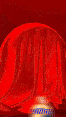 a painting of a red cloth with a yellow circle in the middle