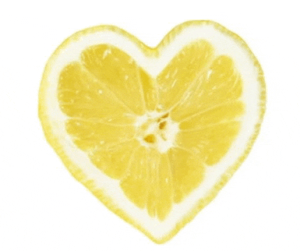a heart shaped slice of lemon on a white surface
