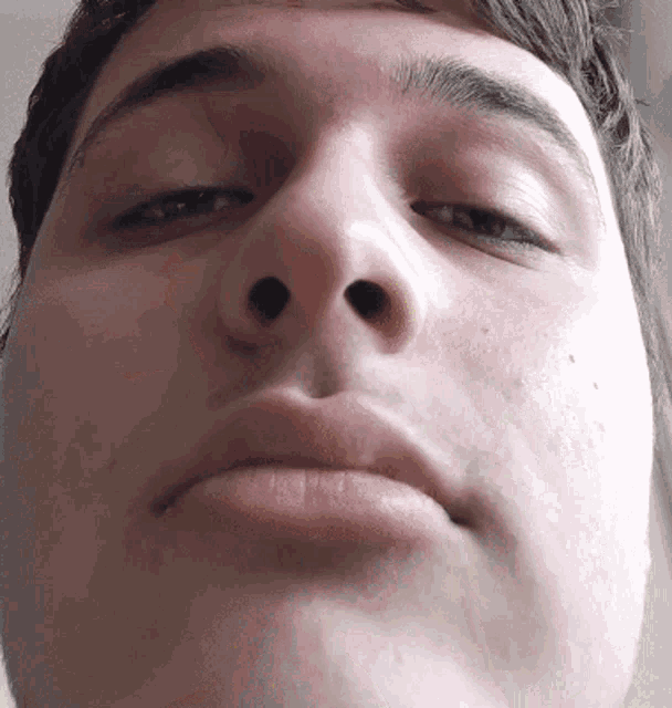a close up of a man 's face with his eyes closed and his mouth open
