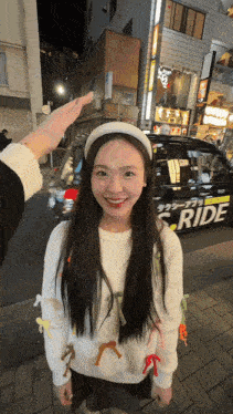 a woman standing in front of a ride taxi