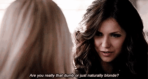 a woman with long hair is talking to another woman and says are you really that dumb or just naturally blonde ?