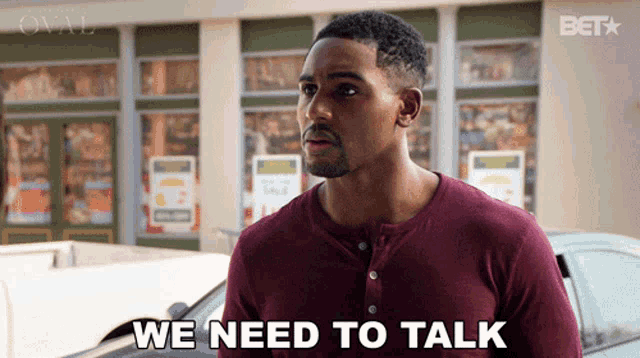 a man says we need to talk while standing in front of a car
