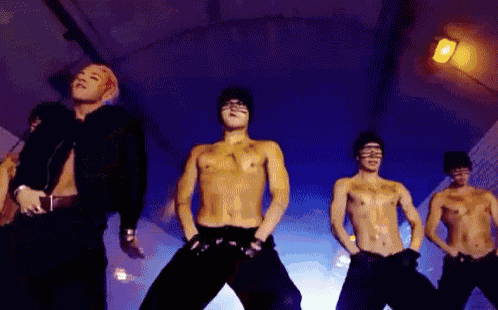 a group of men without shirts are dancing together