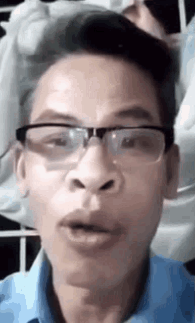 a man wearing glasses is making a funny face .