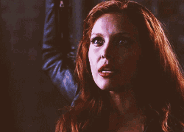 a close up of a woman with red hair