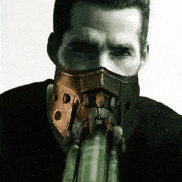 a man with a mask on his face is holding something in his hand