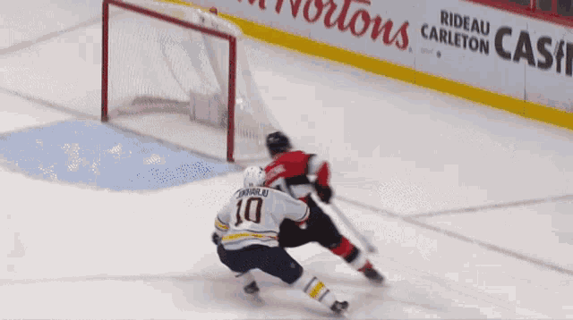 a hockey game is being played in front of a sign that says suitex