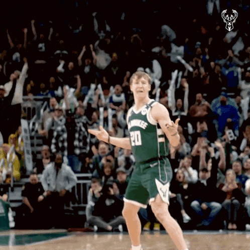 a basketball player with the number 20 on his jersey is dancing on the court