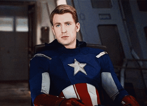 a man in a captain america uniform is sitting down