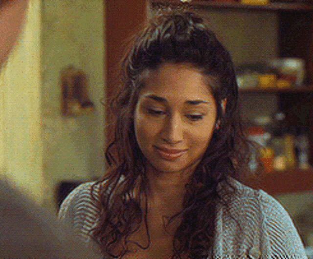 a woman with her hair in a half up half down ponytail